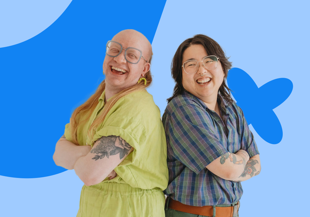 Two smiling individuals standing back-to-back against a bright blue background with abstract shapes, one with long blonde hair and glasses, wearing a yellow dress, and the other with short dark hair and glasses, wearing a plaid shirt, both crossing their arms.