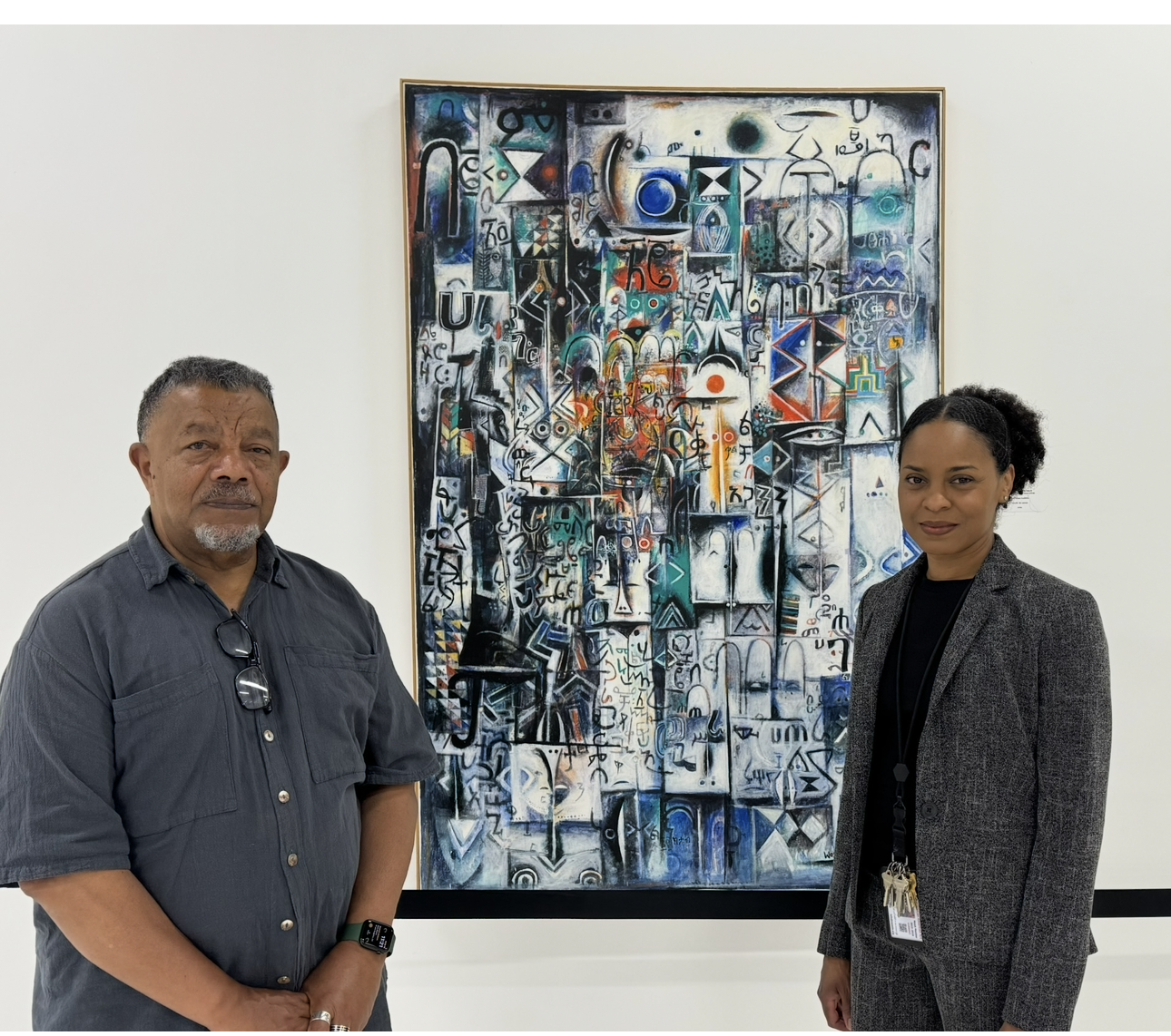 Wosene with Keasha Dumas Heath, Executive Director of Museum of African American Art, Baldwin Hills, CA and his painting, Gods of the Forest (1993), in the permanent collection of the museum.
