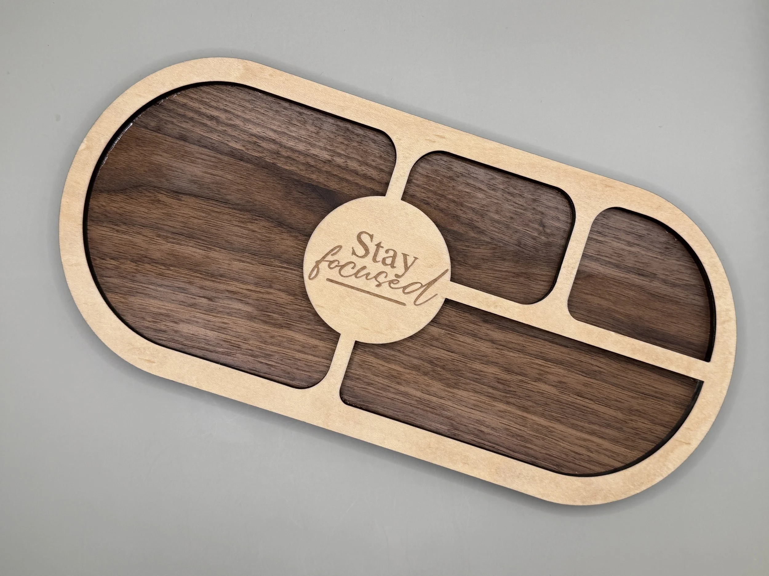"Stay Focused" Walnut & Maple Desk Valet Tray, front view showing engraved medallion and compartments