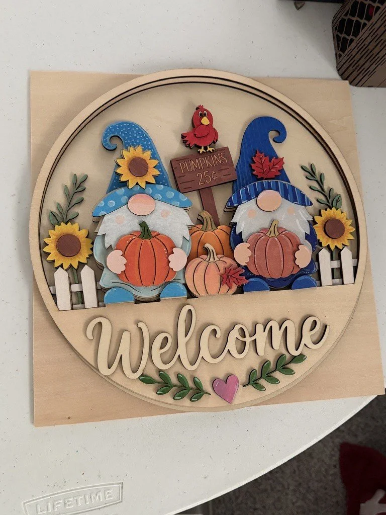 Painted example of Welcome pumpkin gnomes layered wood round sign kit with sunflowers, cardinal and Pumpkins 25 cent sign, 12 inch