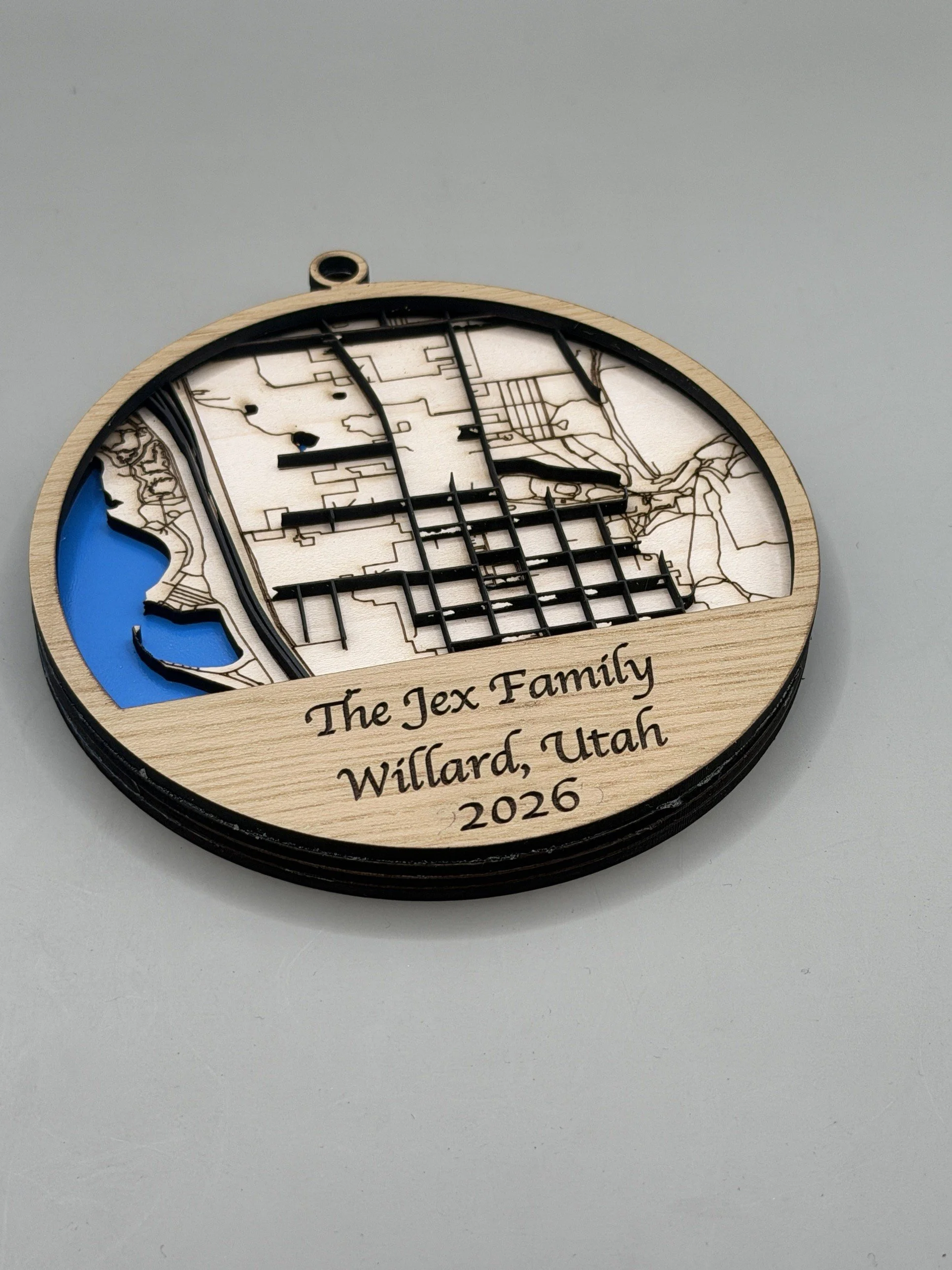 Custom hometown map ornament - The Jex Family, Willard, Utah, angled view showing layered wood