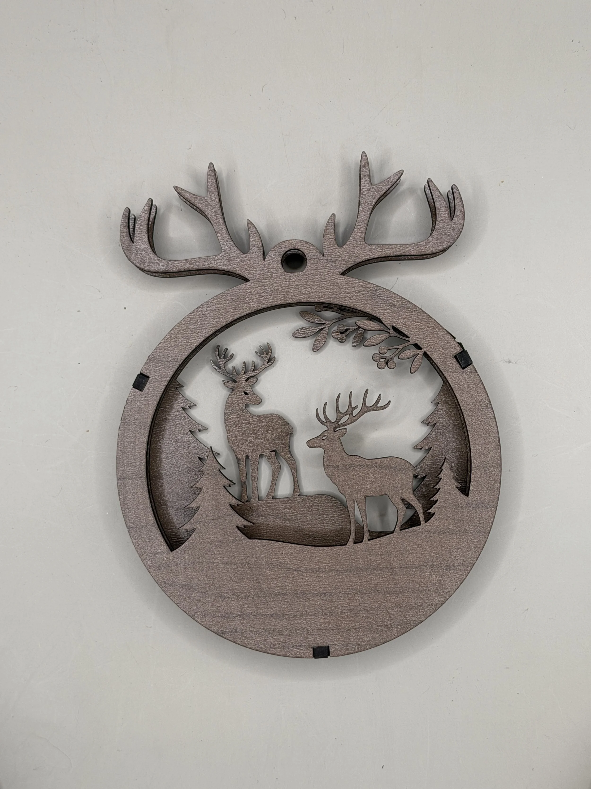 Reindeer antlers layered wood Christmas ornament in walnut, front view