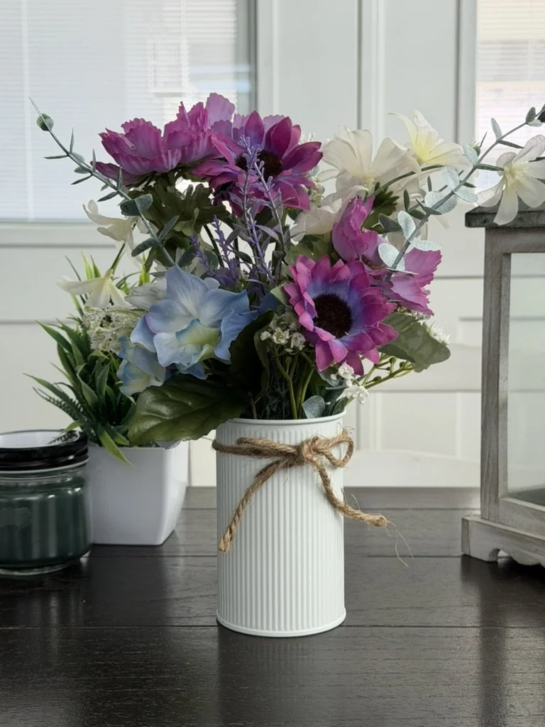 Purple Flower in White metal can vase without money flowers.