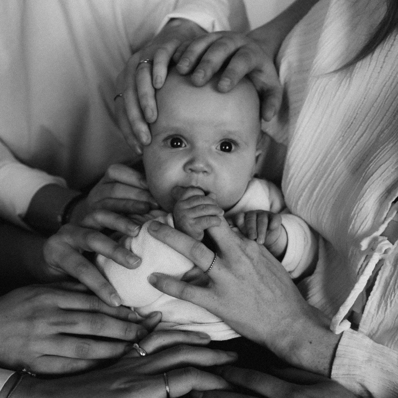 A person wrapped in a large, fluffy, brown faux fur coat or blanket, with their face partially visible and one eye showing.