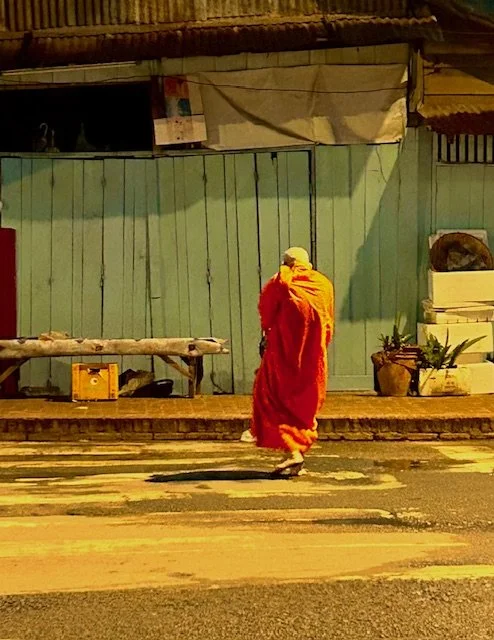 An older Monk walking back to his temple after the alms ceremony.