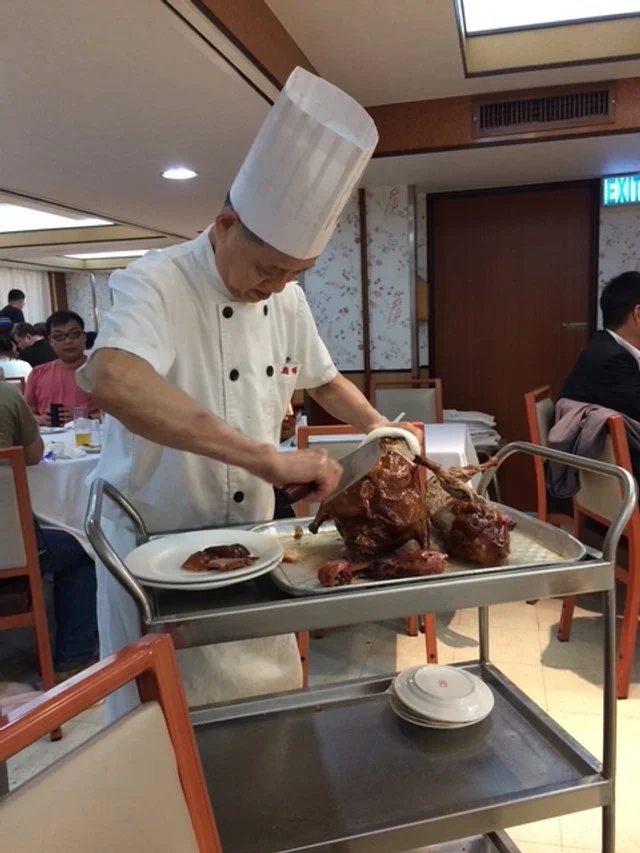 Chef carving a Peking Duck