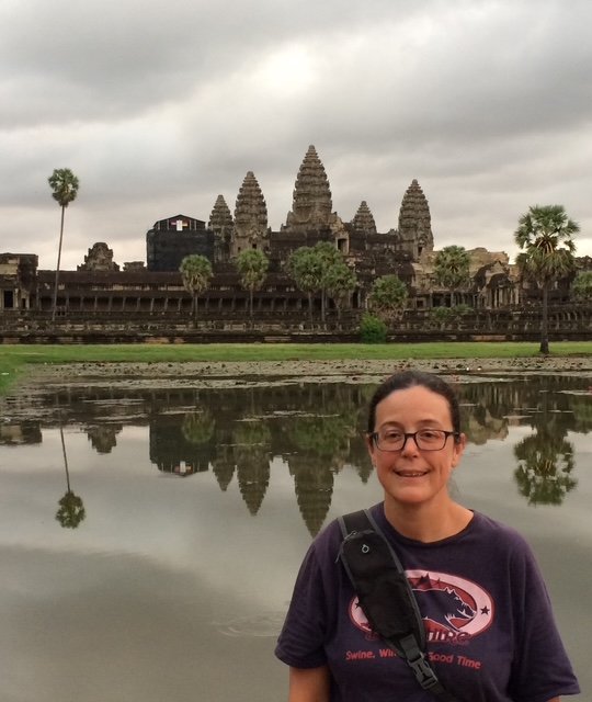 OBT in front of Angkor Wat temple reflected in a body of water.