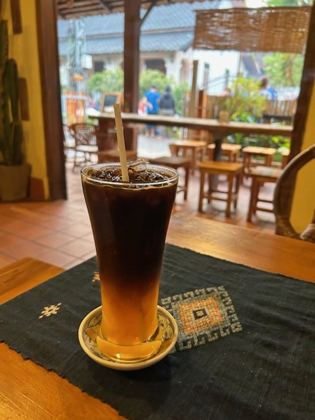 A glass of iced coffee with orange juice.  Surprisingly delicious. Cafe in the morning market.