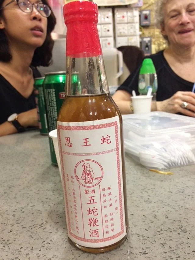 A small glass bottle with Snake Penis Wine