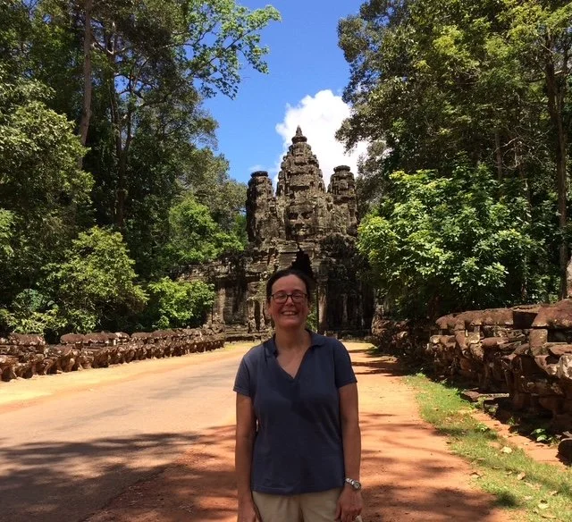 OBT standing on a dirt path in front of an ancient stone temple called Uncle Thom