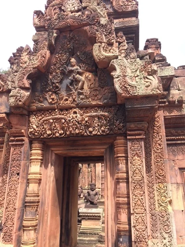 Ornately carved stone doorway with intricate designs and sculptures, leading into a temple or historic structure. Outer temples, Angkor Wat