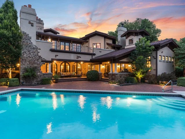 Luxury house with a swimming pool at sunset.