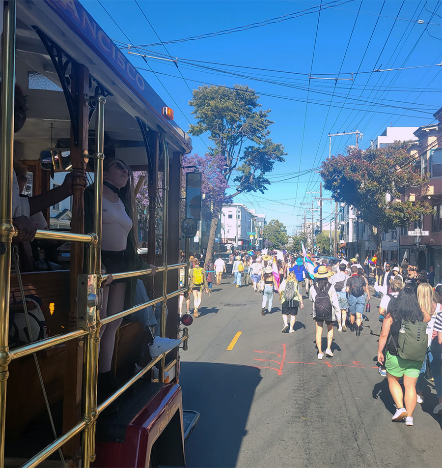 The accessibility trolly (at left), rolling in the SF Dyke March 2025