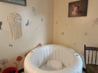 The birthing tub in our Boho birthing suite with a support partner chair