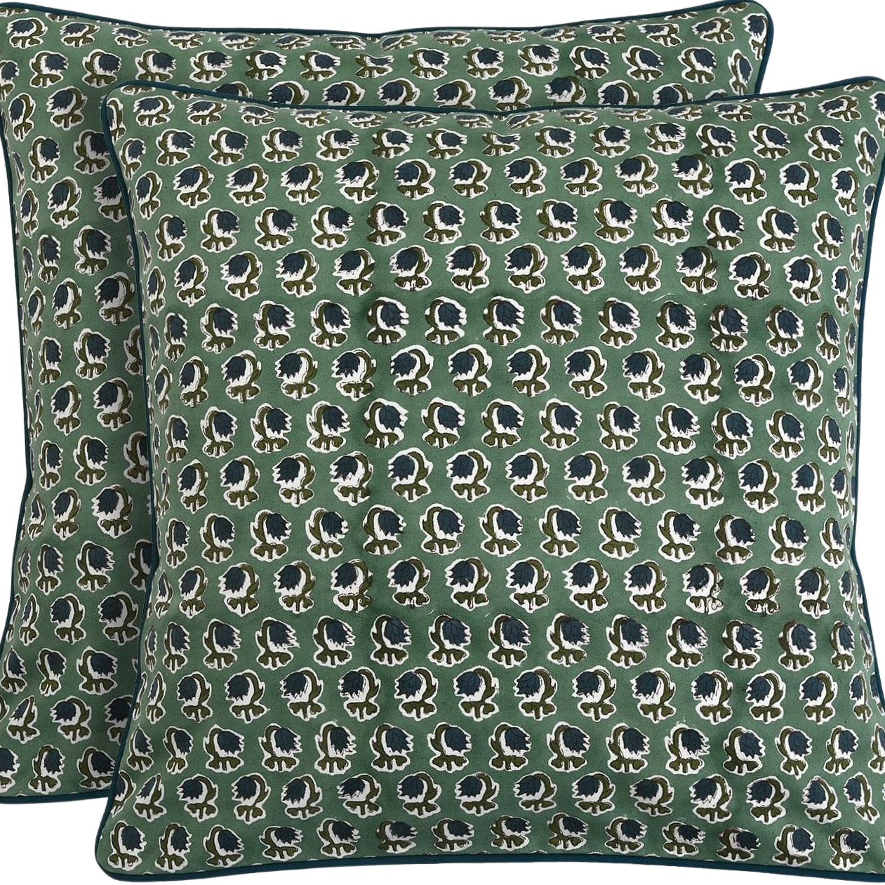 A green pillow and a bedsheet with a repetitive pattern of black African elephants with white outlines.