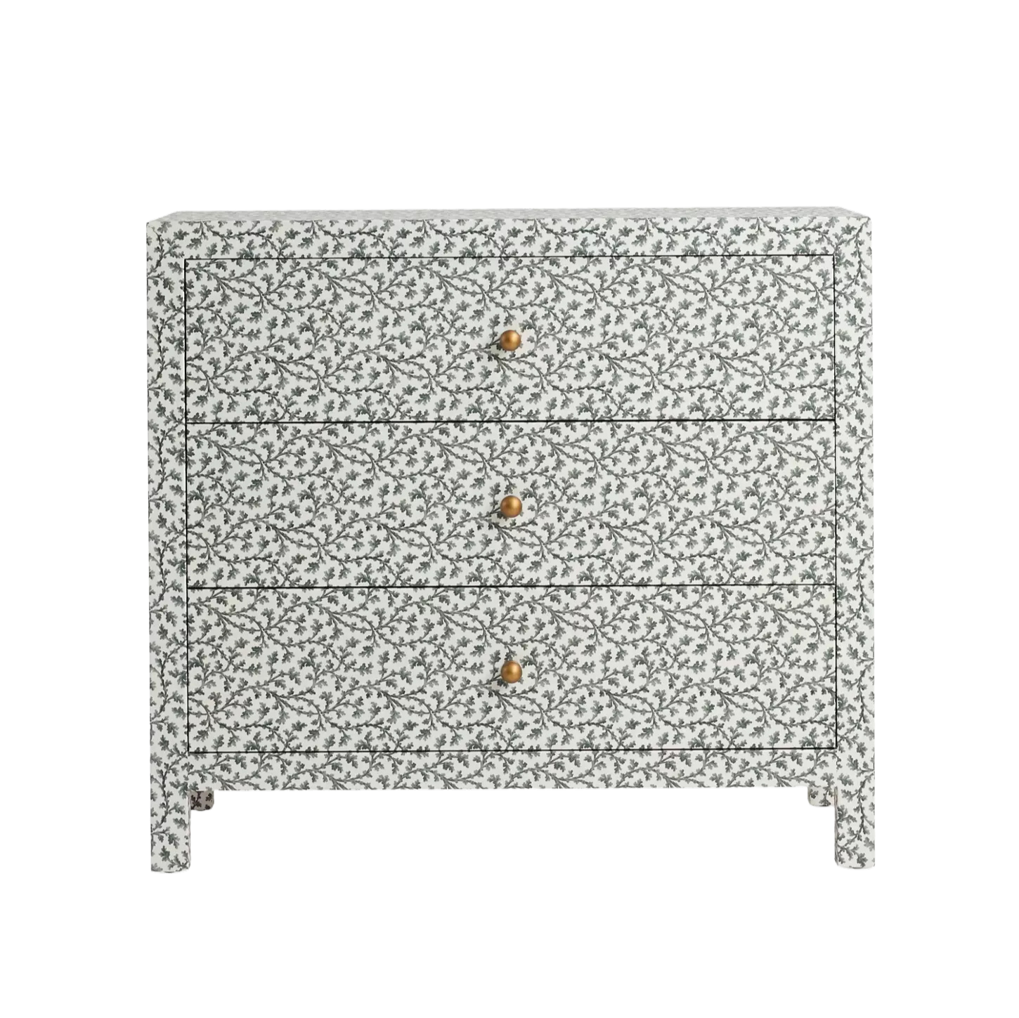 A white dresser with a gray and white leafy pattern, three drawers with gold knobs, and a black base.