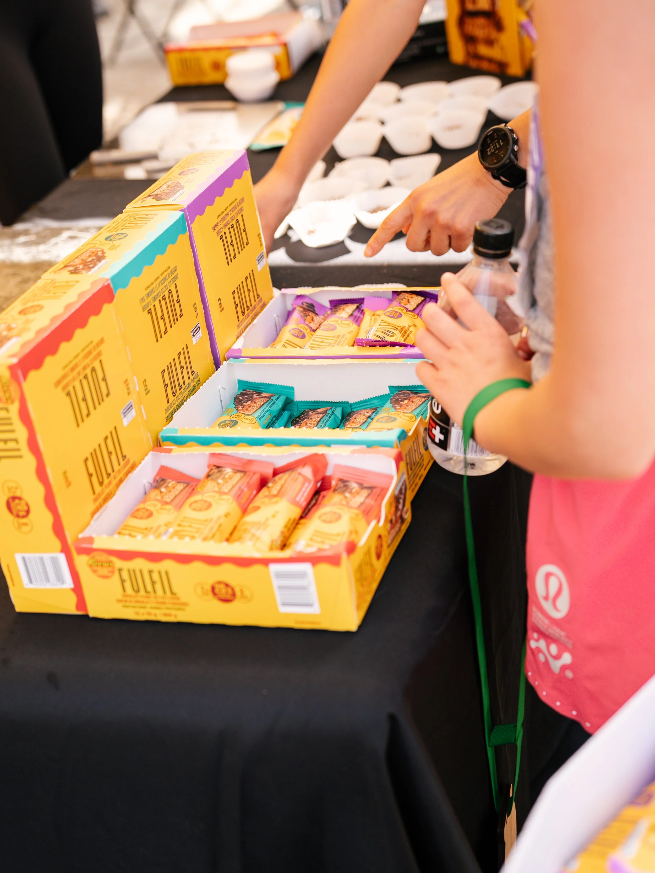 Fulfil protein bars in display boxes lined up on a table.