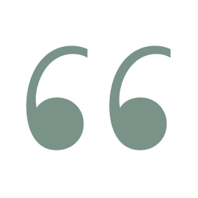 Quotation marks in a stylized font.