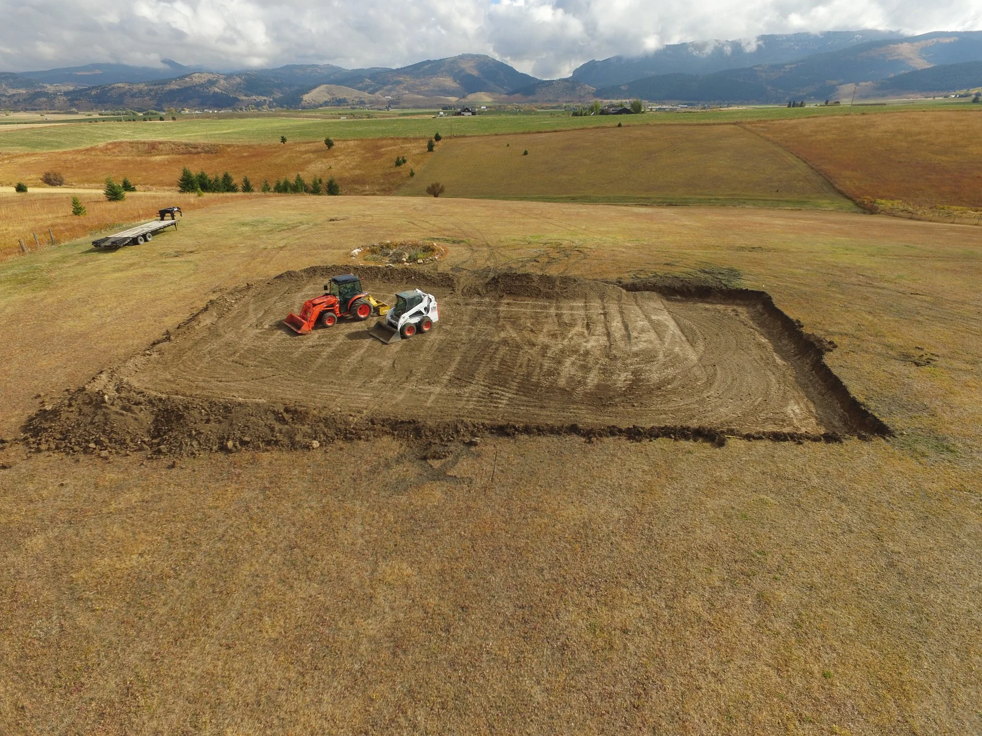 Using machinery to level the ground for an ice rink