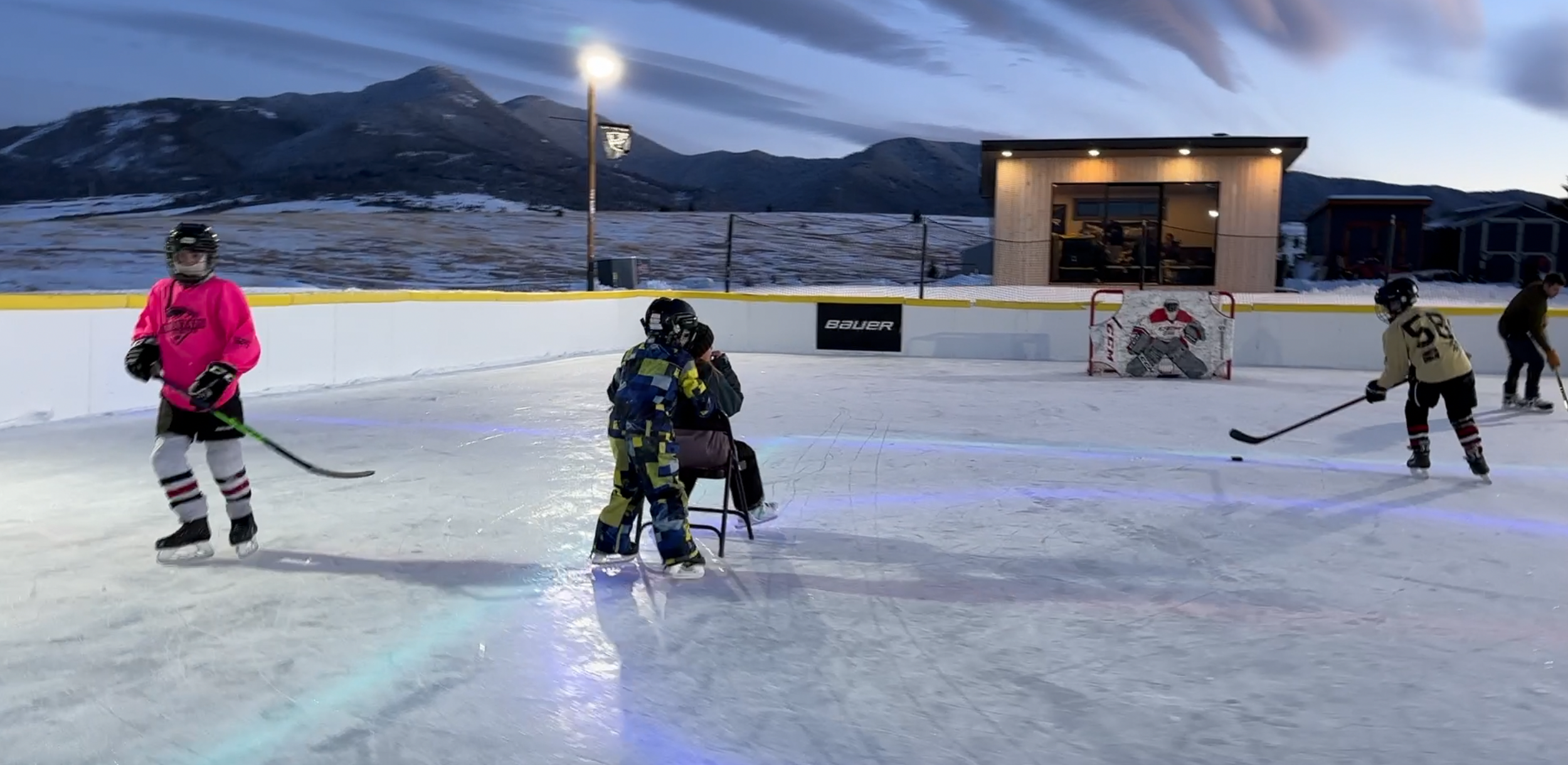 kids skating and playing on hockey on outdoor rink