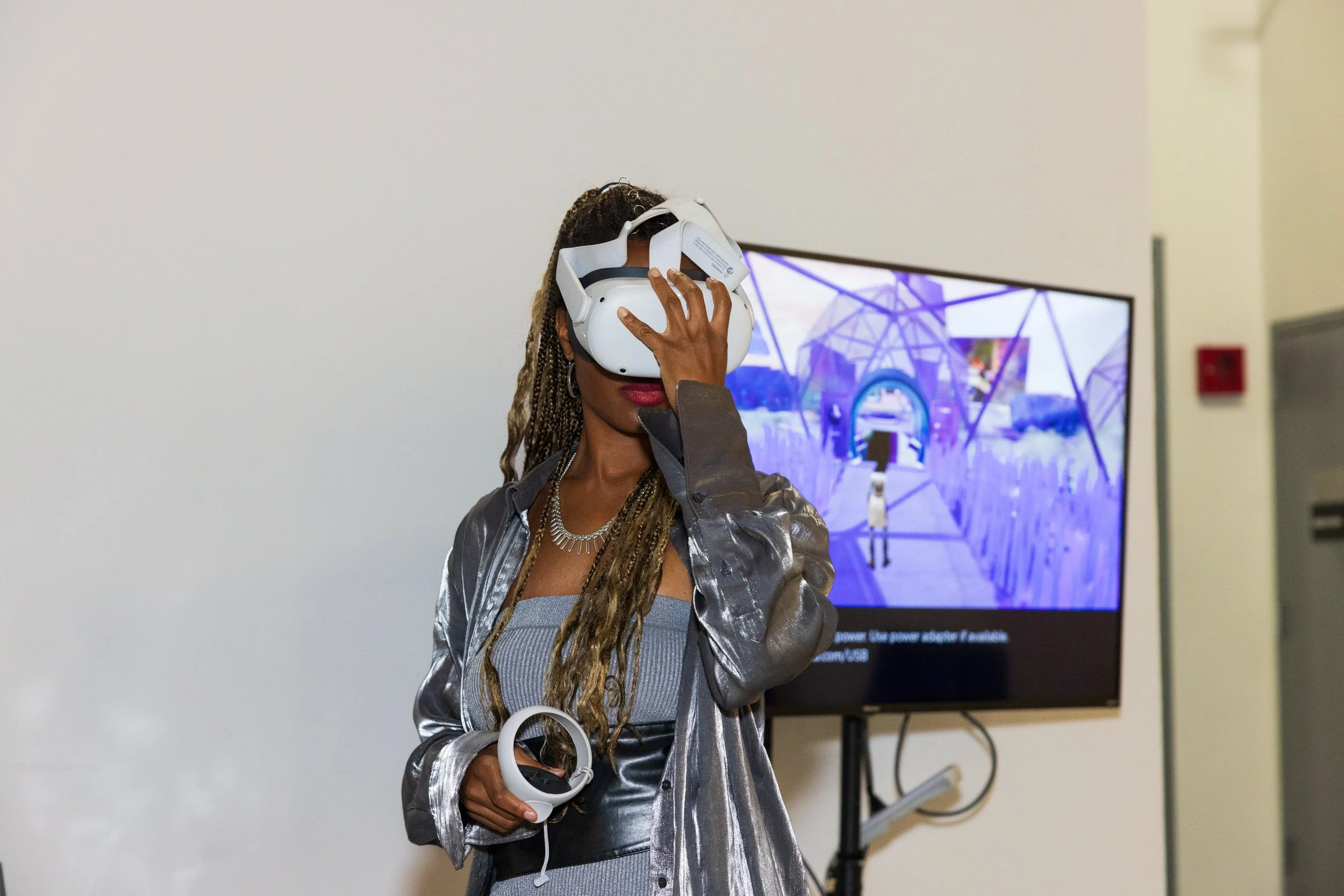 Woman using virtual reality headset during demonstration indoors.