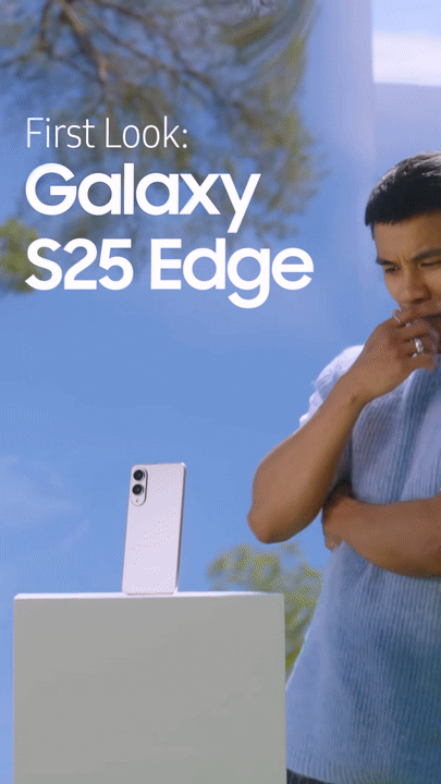 A person observing the Samsung Galaxy S25 Edge smartphone on display outdoors against a blue sky and trees.