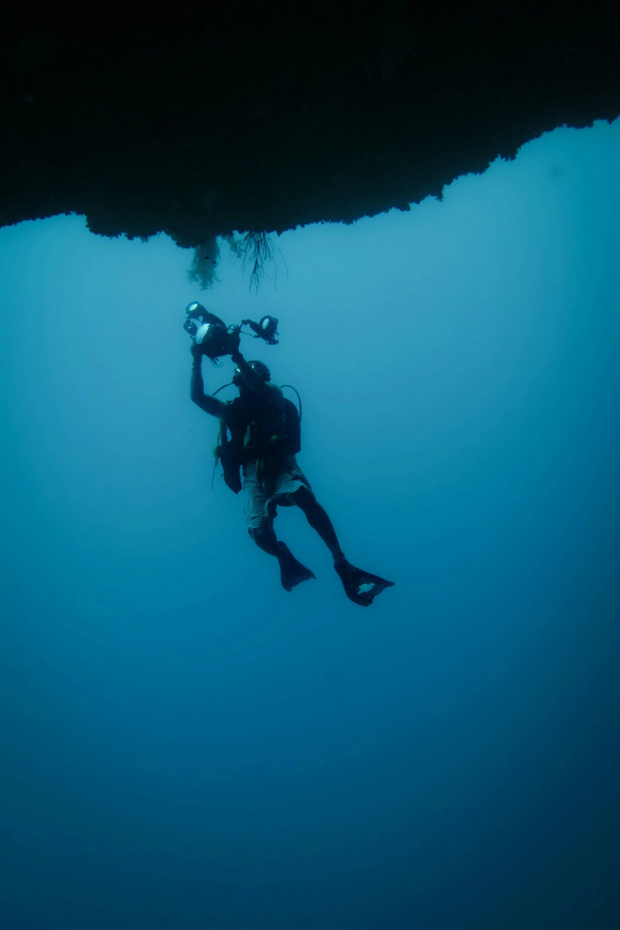 Plongée sous-marine avec un plongeur explorant une grotte ou un récif sous l'eau.