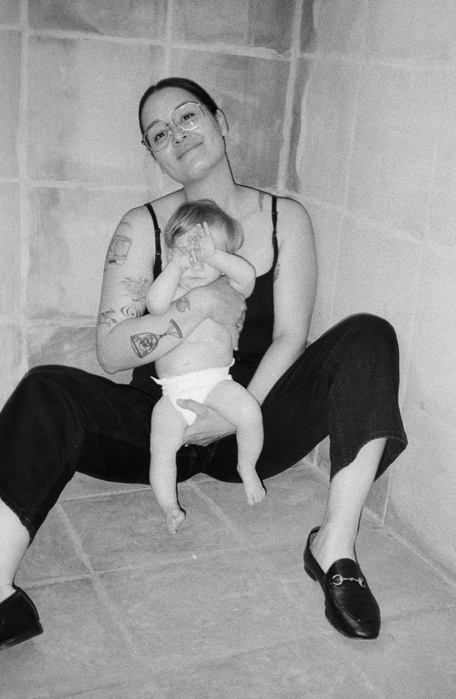 Photo of photographer Colleen Phan-Eversman holding her infant son taken by Jessica Holleque.
