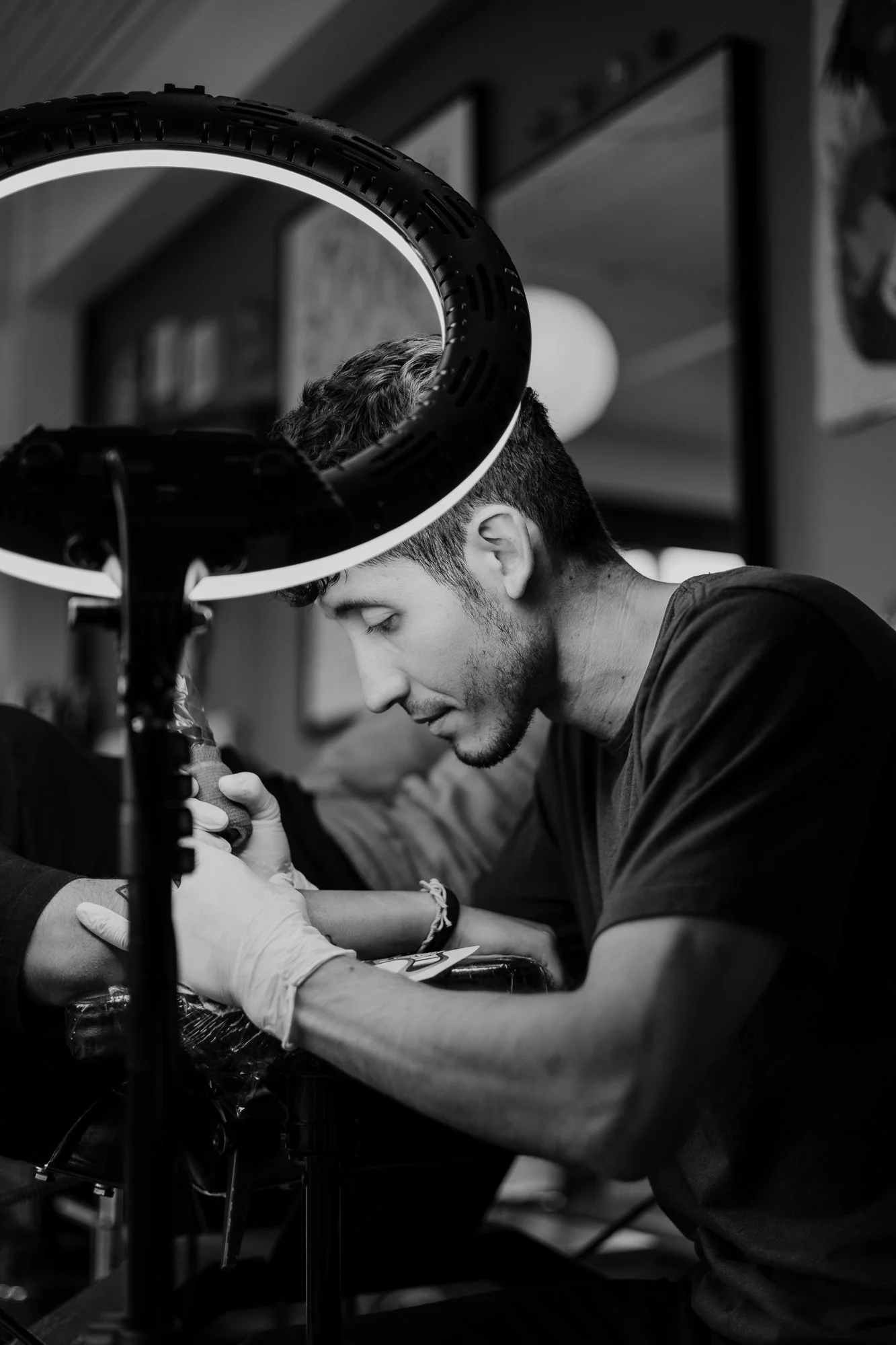 Tattoo artist in session black white