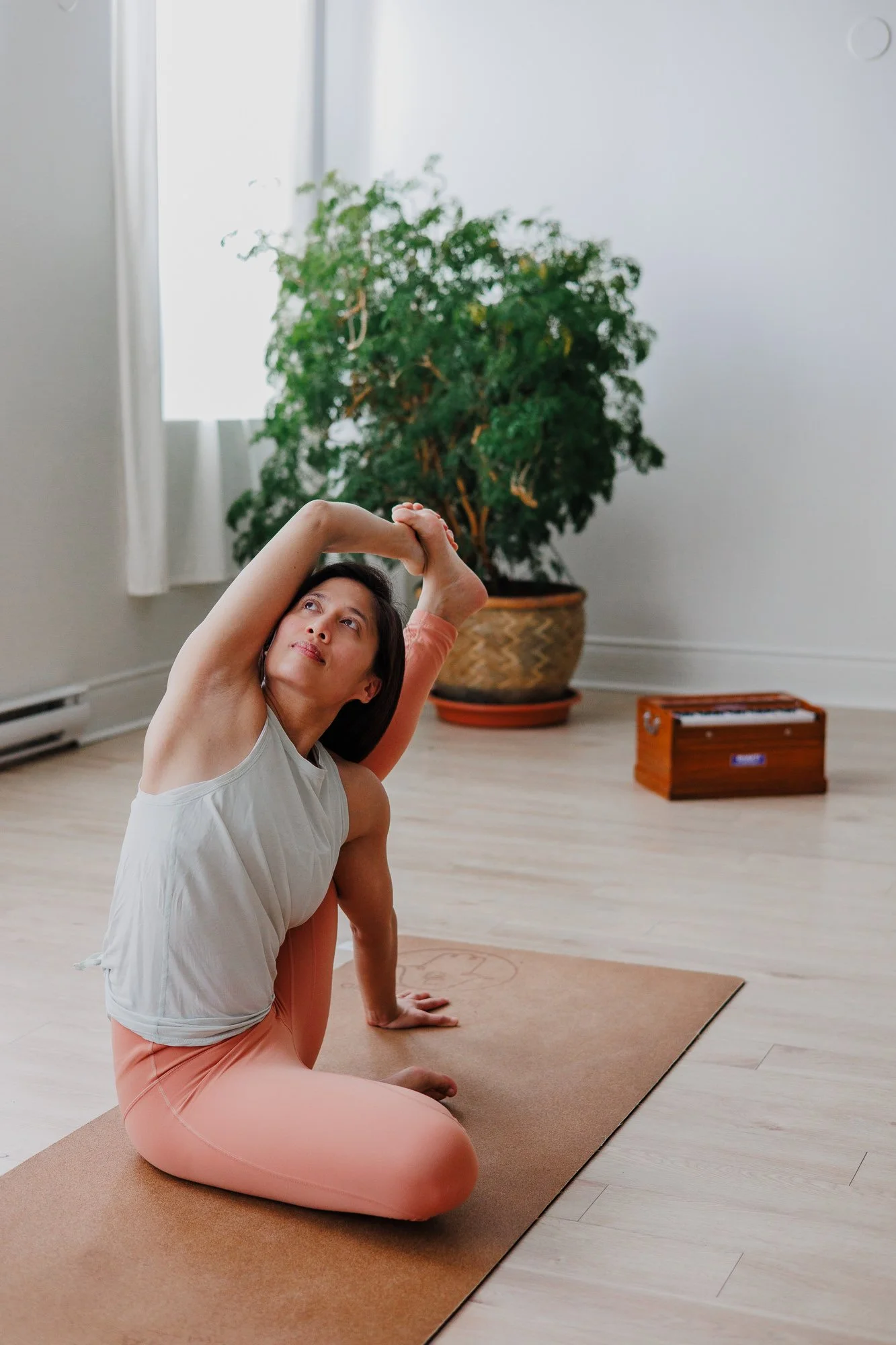 Woman yoga teacher doing compass pose