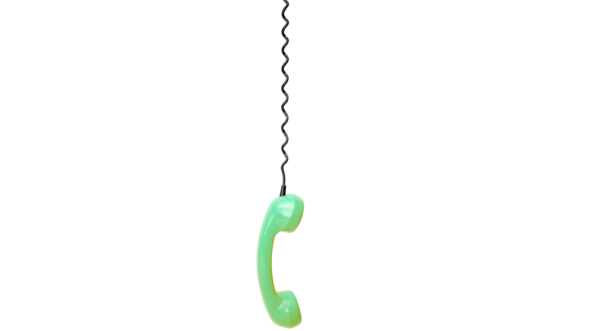 A vintage rotary telephone with a light green body and a curved handset, placed on a yellow surface. The background is a mix of black and purple.