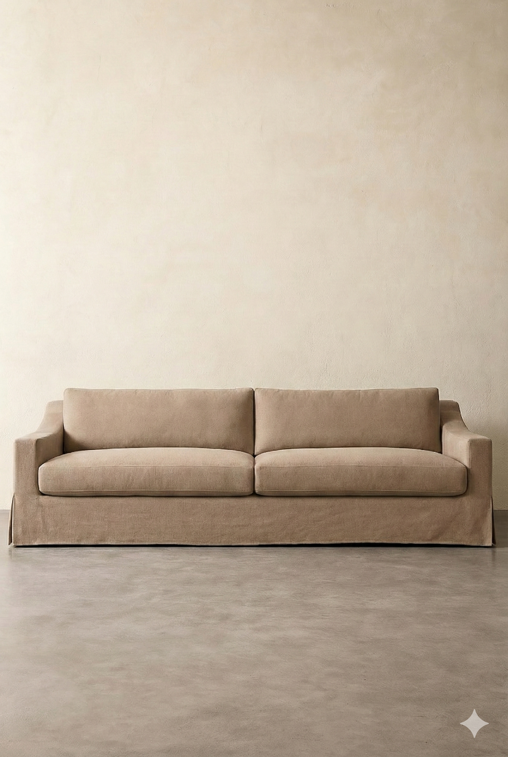 A beige sofa against a light-colored wall on a light gray floor.