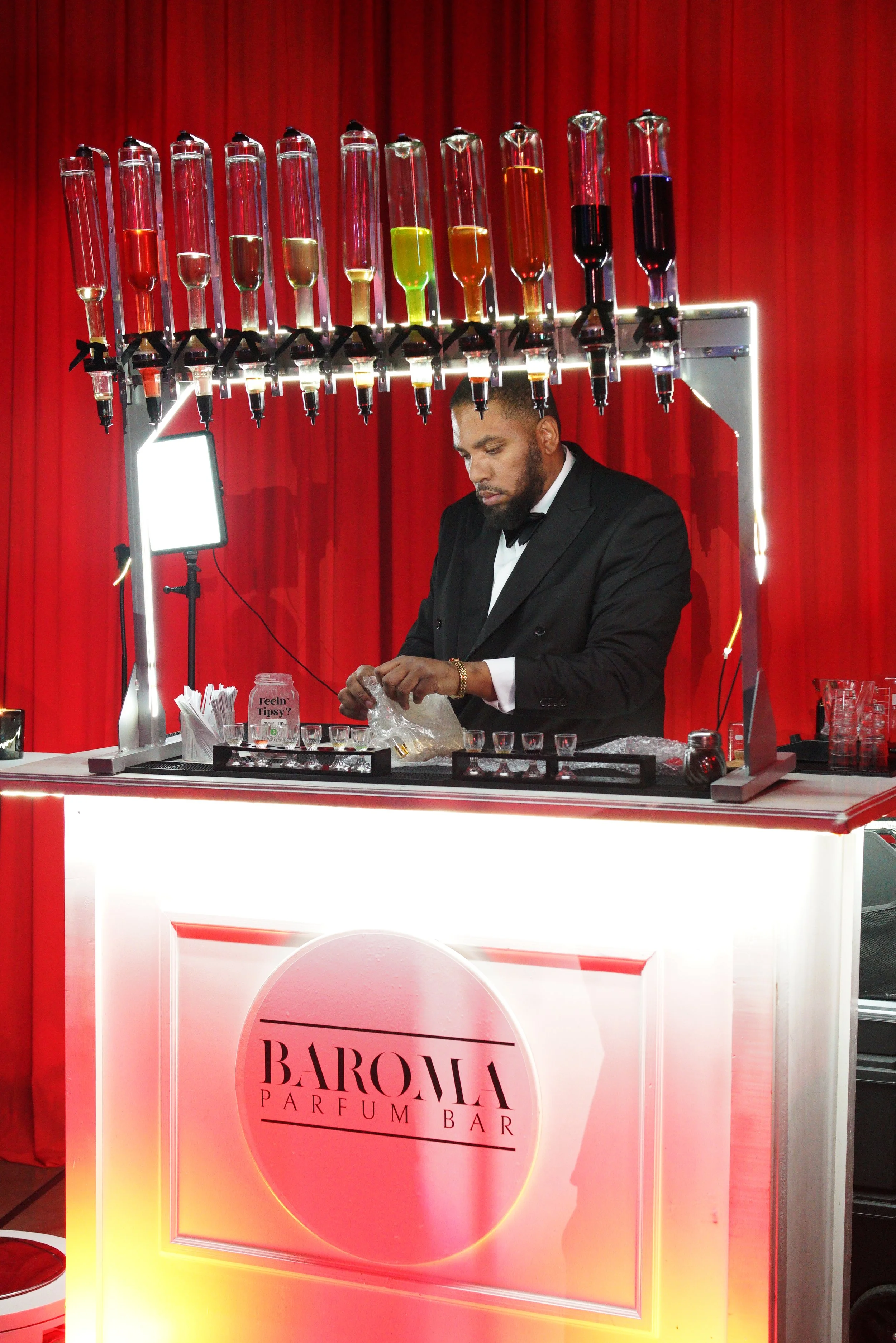 Baroma Parfum Bar founder at the fragrance bar, leading a luxury mobile perfume bar experience and professionally curating custom fragrances during an upscale Atlanta event.