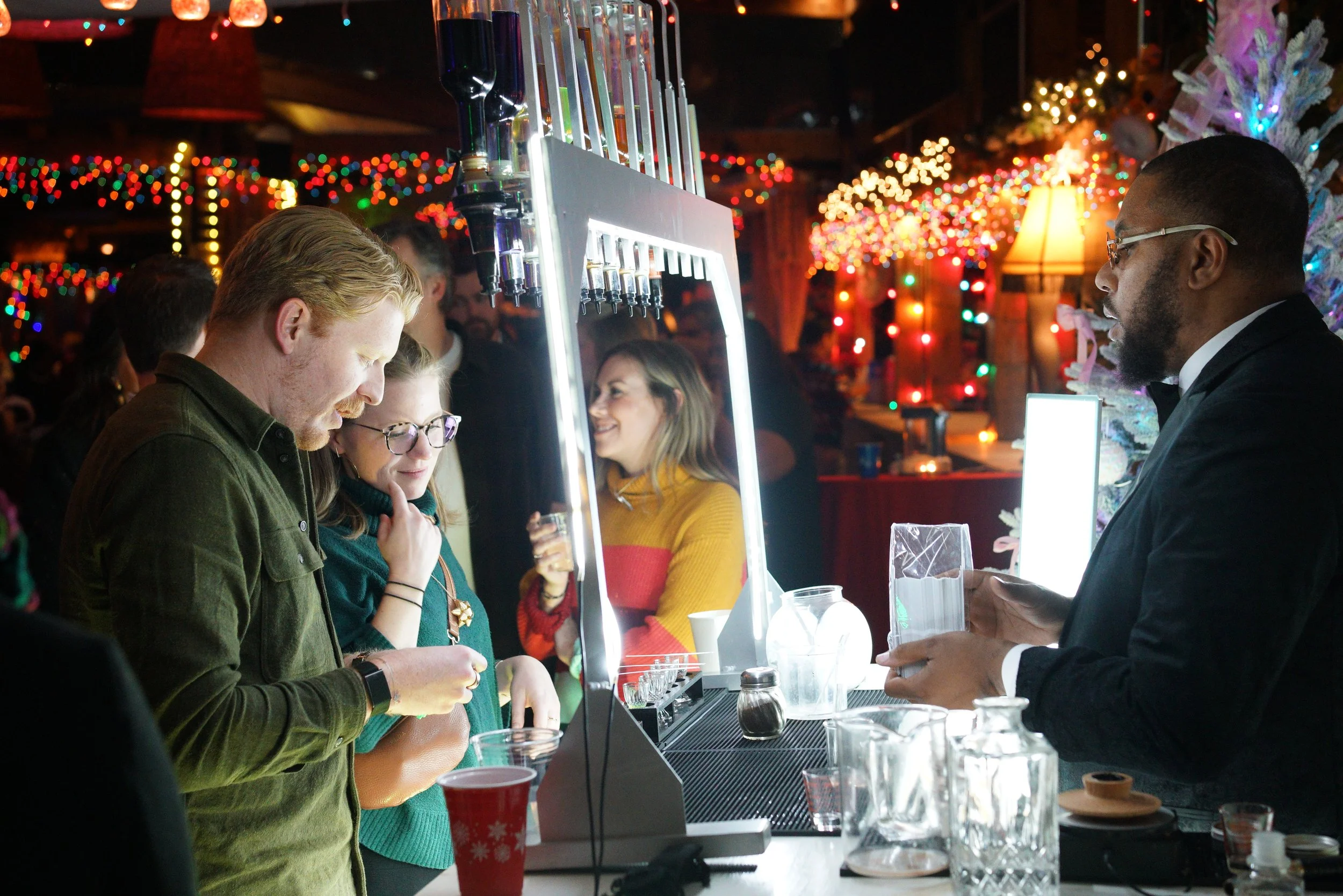 Guests enjoying a custom perfume experience at a Delta Christmas party activation, as Baroma Parfum Bar professionally curates and creates fragrances on site during a luxury corporate holiday event.