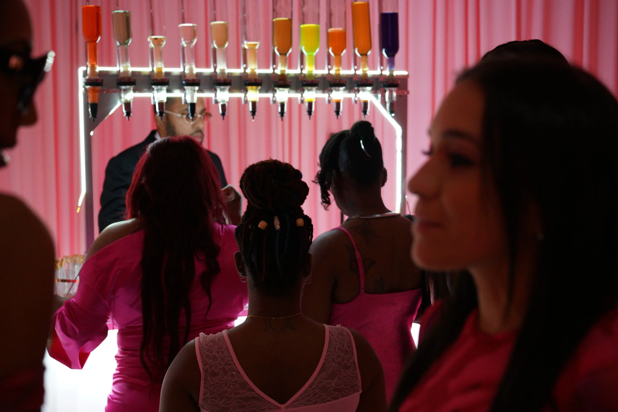 Women gathered around a luxury mobile perfume bar by Baroma Parfum Bar, experiencing a guided custom perfume service as fragrances are professionally curated for guests at an upscale Atlanta event.