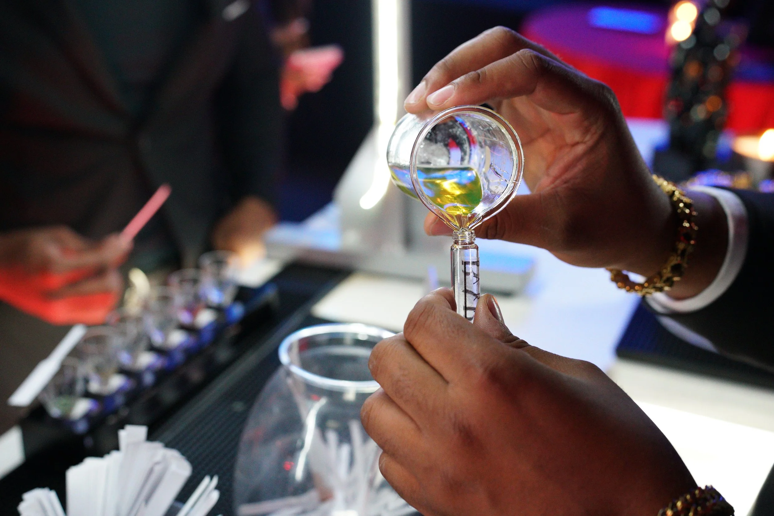 Baroma Parfum Bar founder pouring a freshly blended custom fragrance on site, showcasing the hands-on, professional process behind a luxury mobile perfume bar experience in Atlanta.