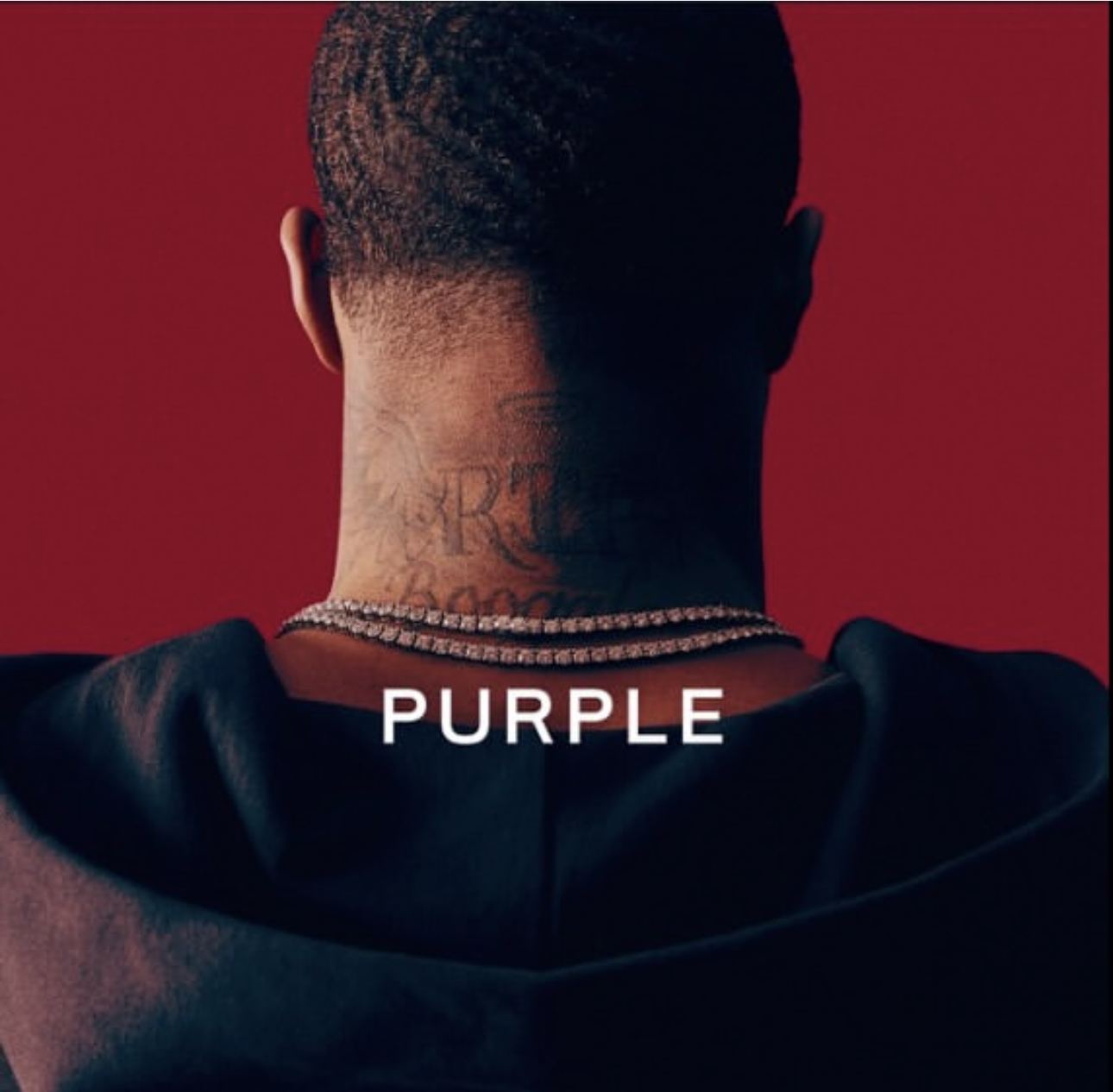 Back of a man with short hair, wearing a black hoodie, a diamond necklace, and sporting tattoos on the neck, standing against a red background, with the word 'PURPLE' written across the bottom.