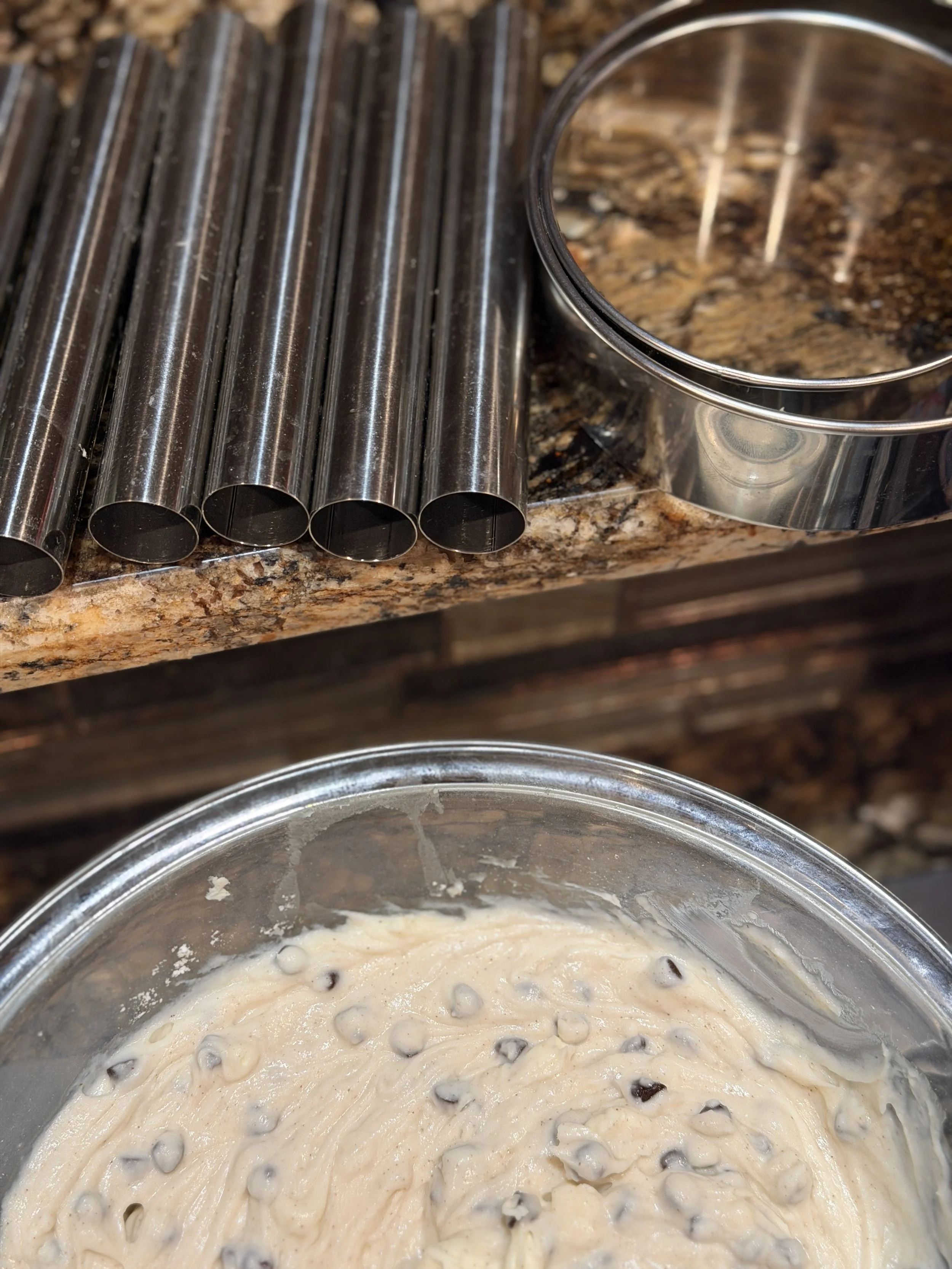 stainless steel cannoli forms and cookie cutters with cannoli filling
