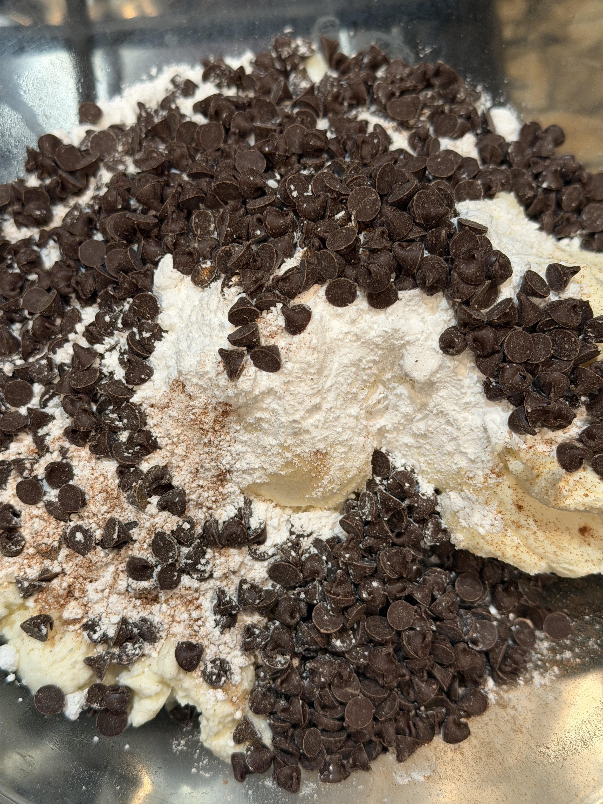 Cannoli filling ingredients before mixing, a mound of cheeses and chocolate chips