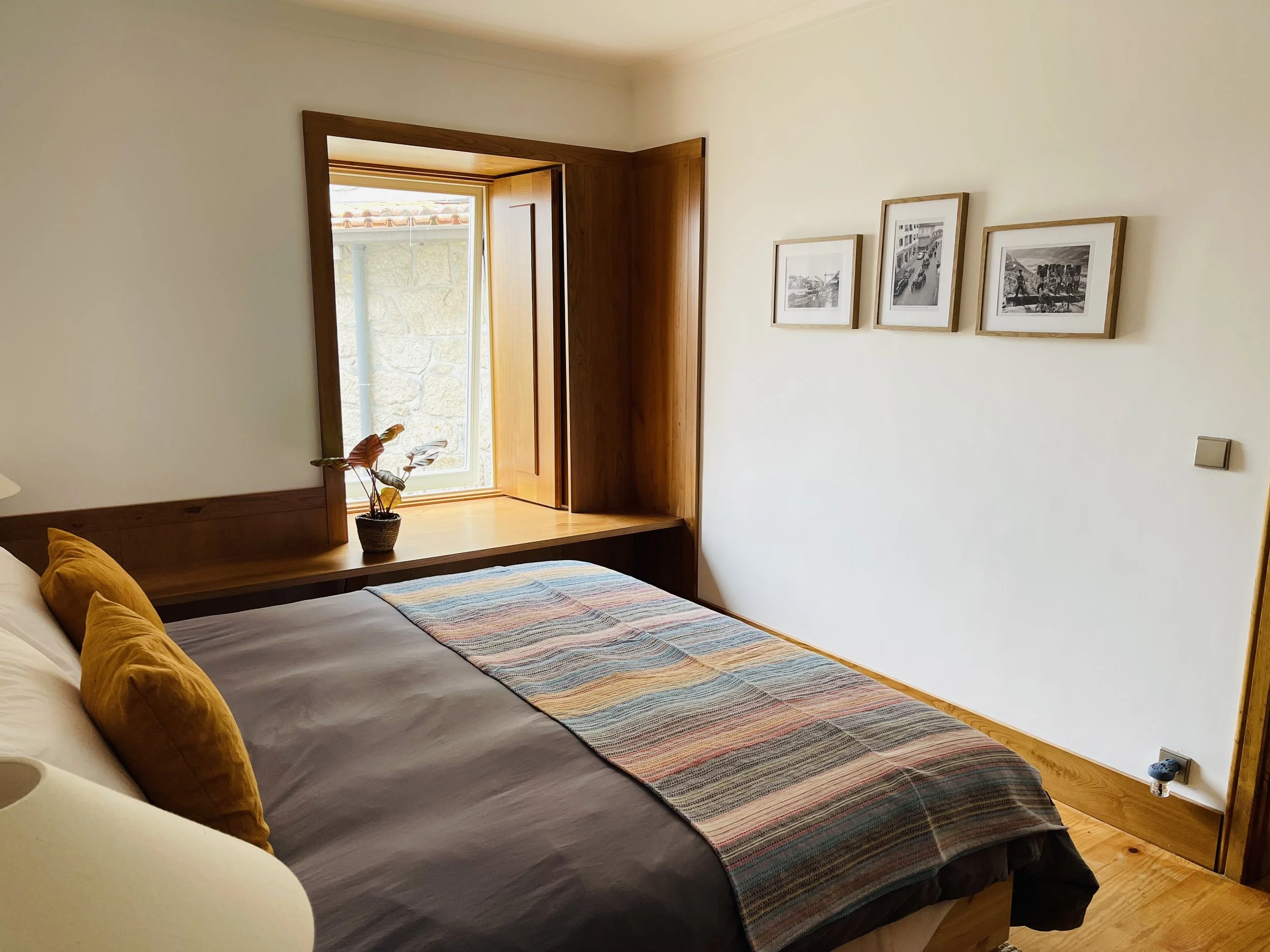 Quaint, charming Kiwi House bedroom featuring an enlarged window looking out onto the back patio