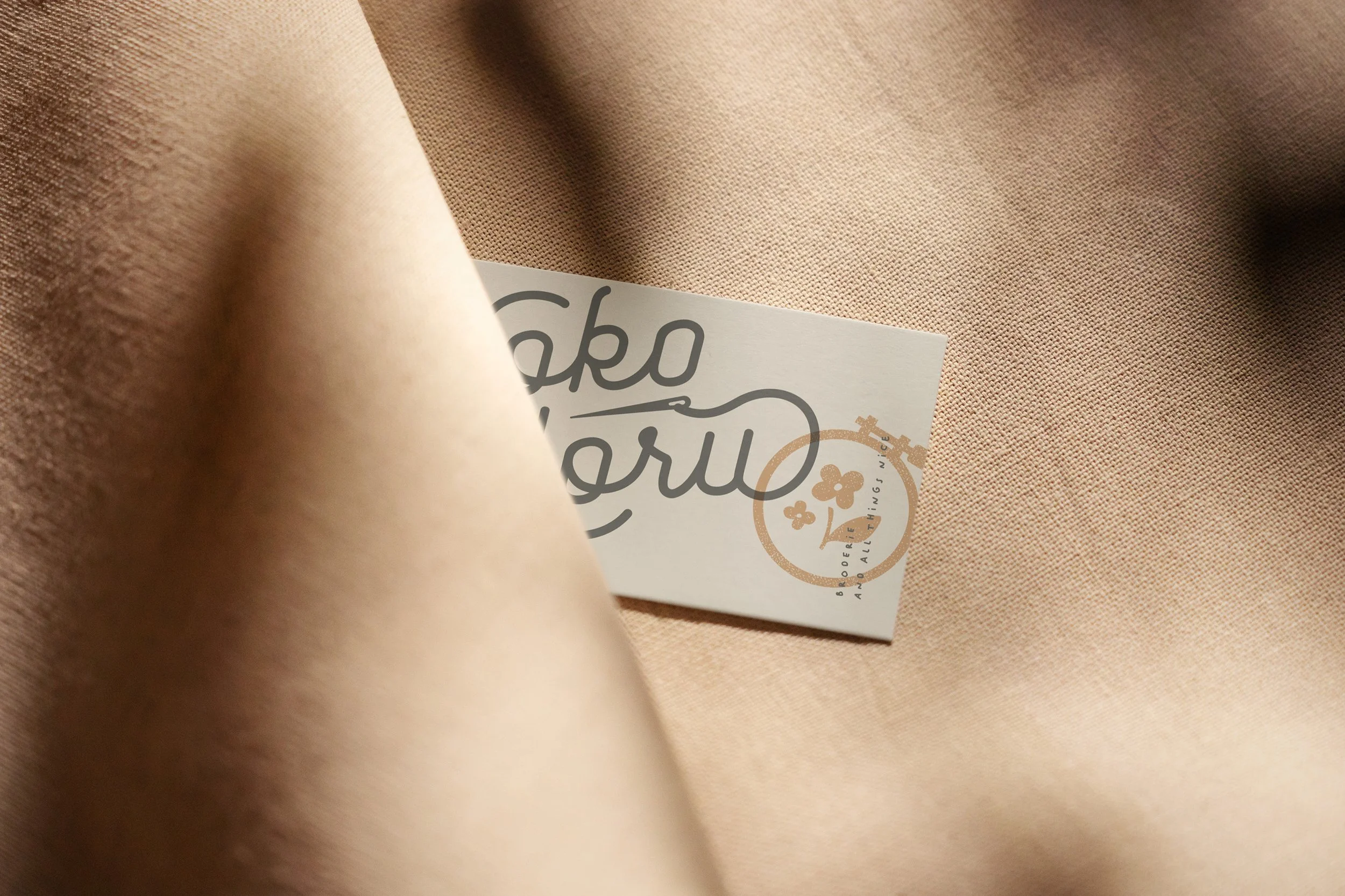 A hand embroidery small business logo featuring hand drawn hoop and needle