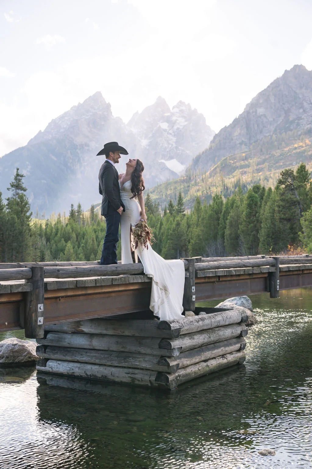 grand-teton-wedding-bridge-bride-groom-flowing-dress-jackson-hole-photographer.jpg