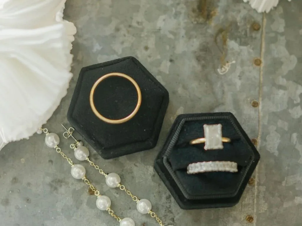 flare of a wedding dress, pearl earrings, wedding bands in boxes: Trenna B Photography Wedding Photographer Jackson Hole