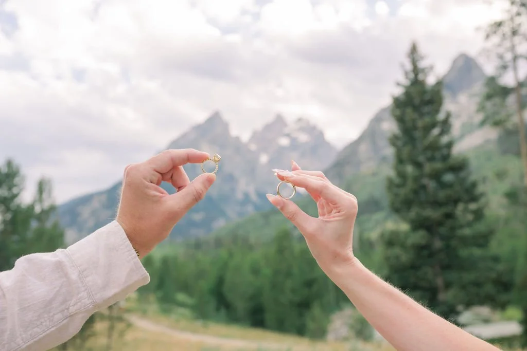 Grand Targhee Wedding with Bride and Groom holding wedding bands