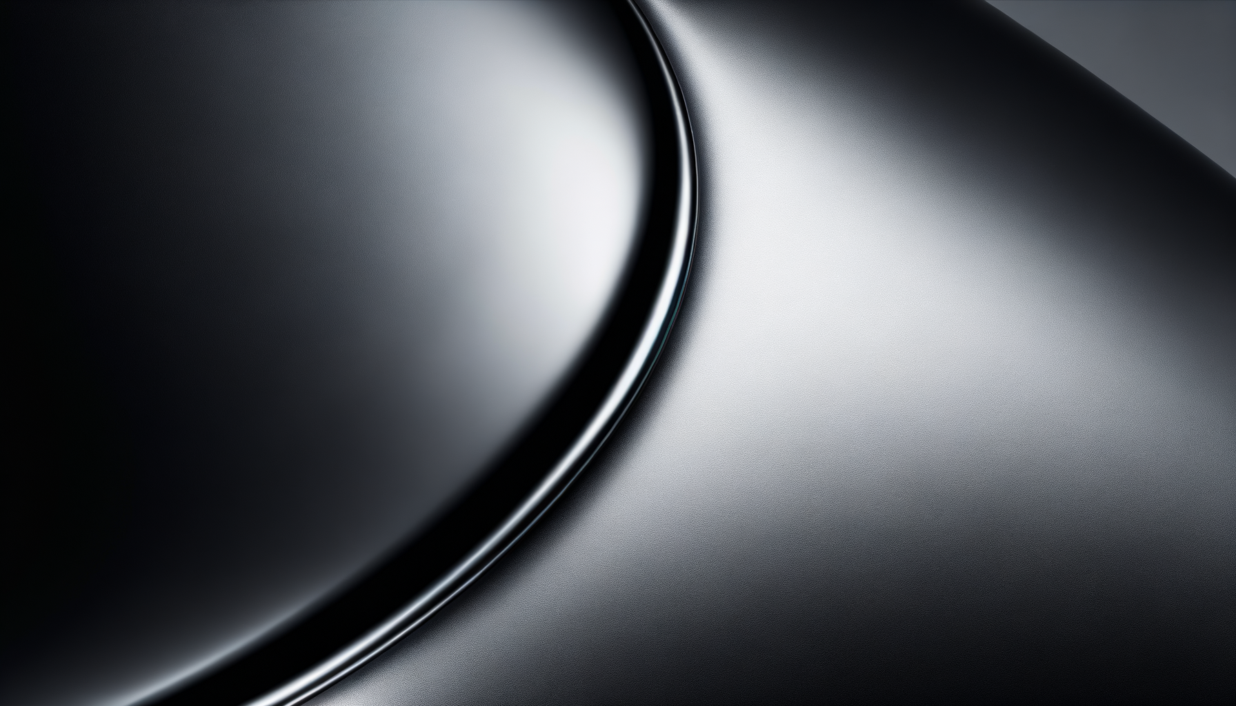Close-up of a metallic, curved surface with a reflective, smooth finish.