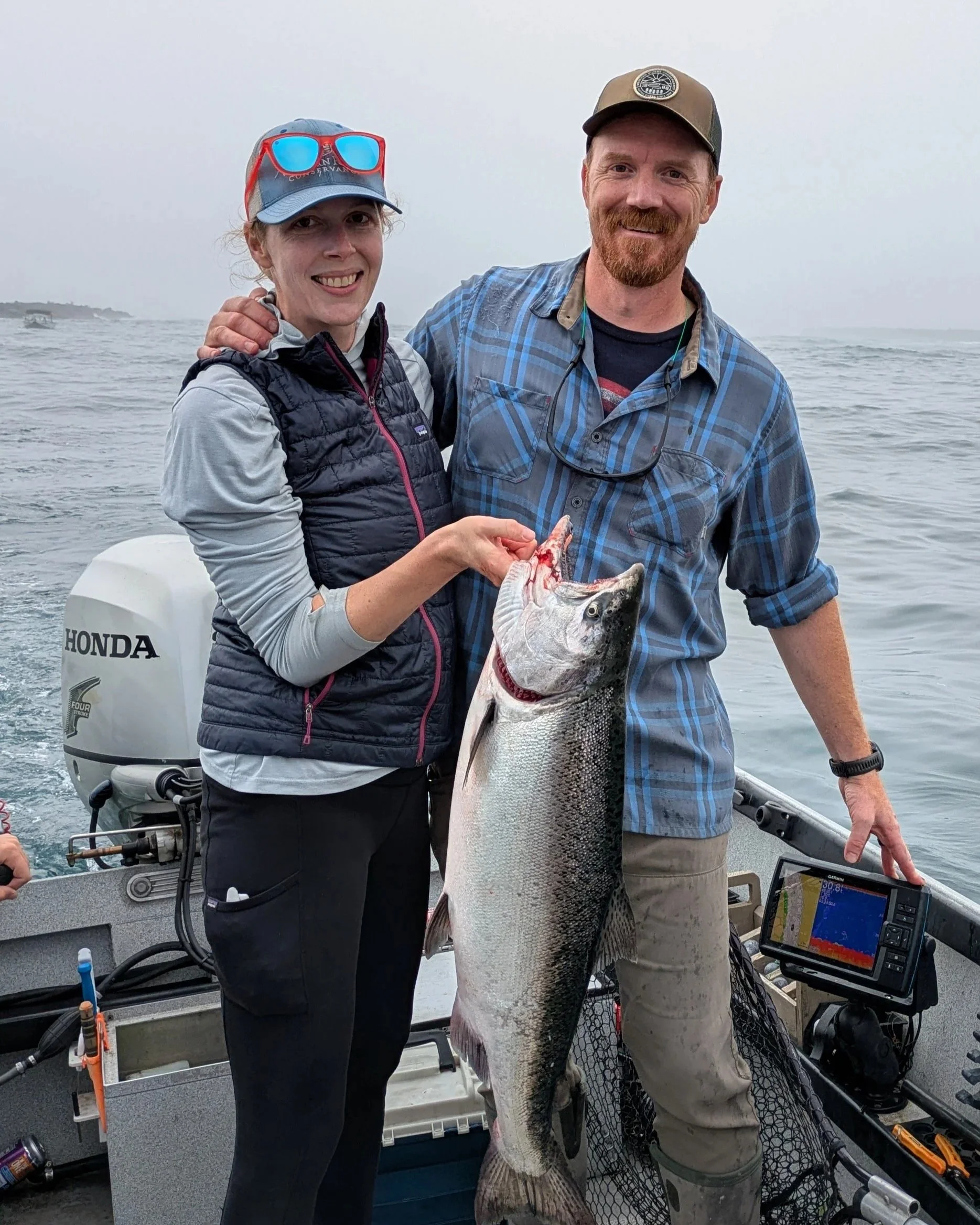 Man and woman with a nice fall chinook salmon.