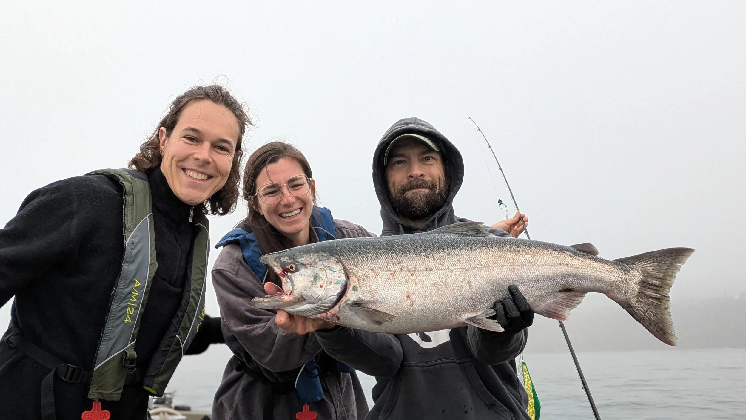 Man and his friends holding a nice fall chinook from Buoy 10.