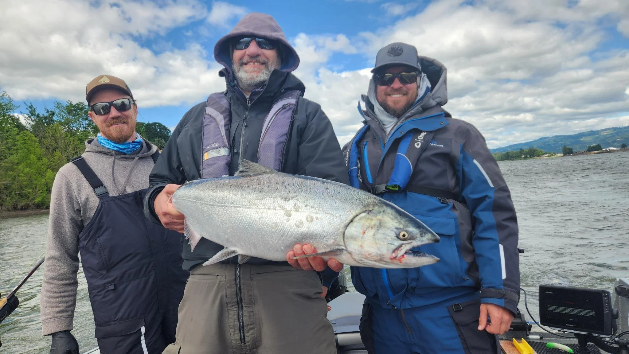Angler holding a big spring chinook salmon caught on the Columbia River.