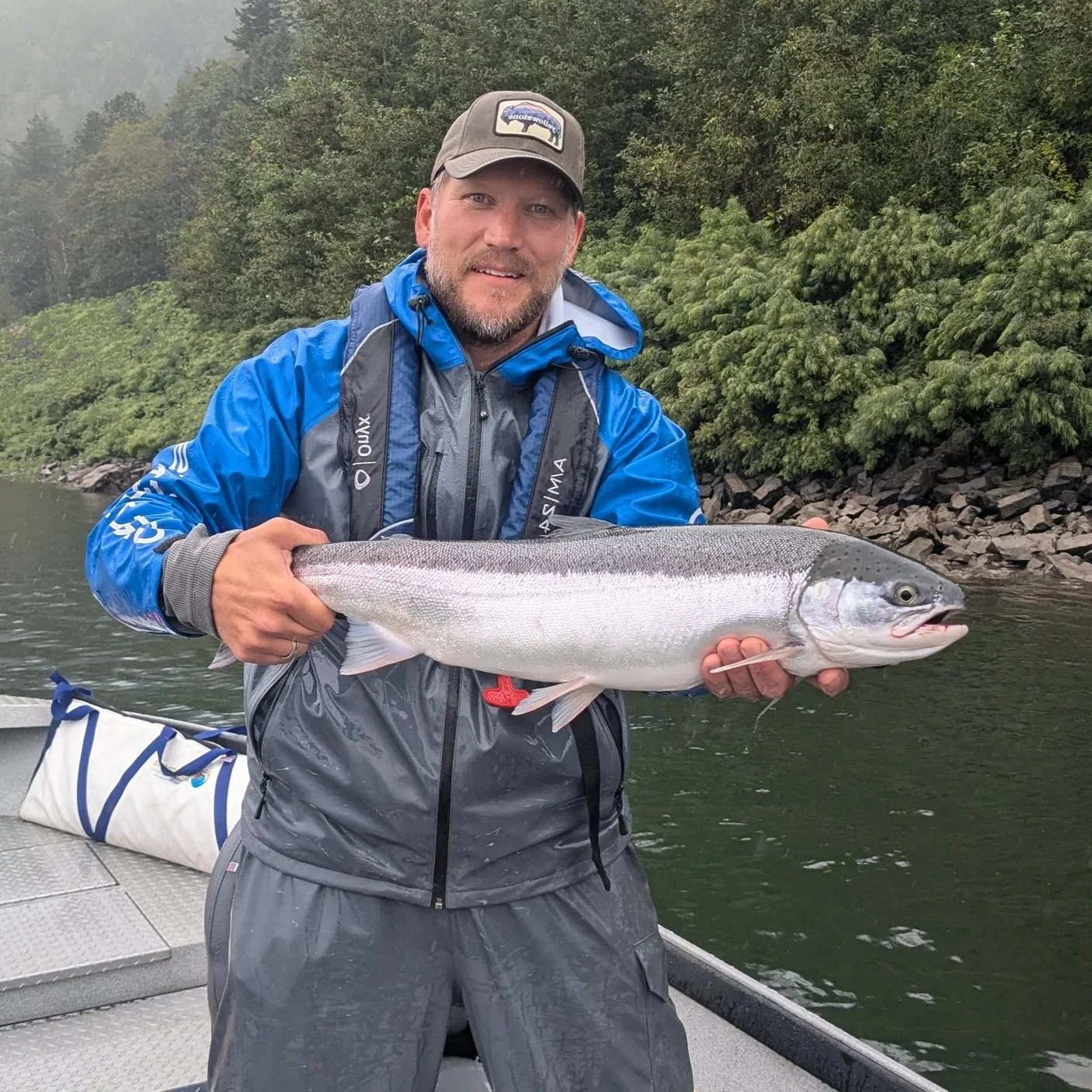 Angler holding a summer steelhead caught on the Columbia River