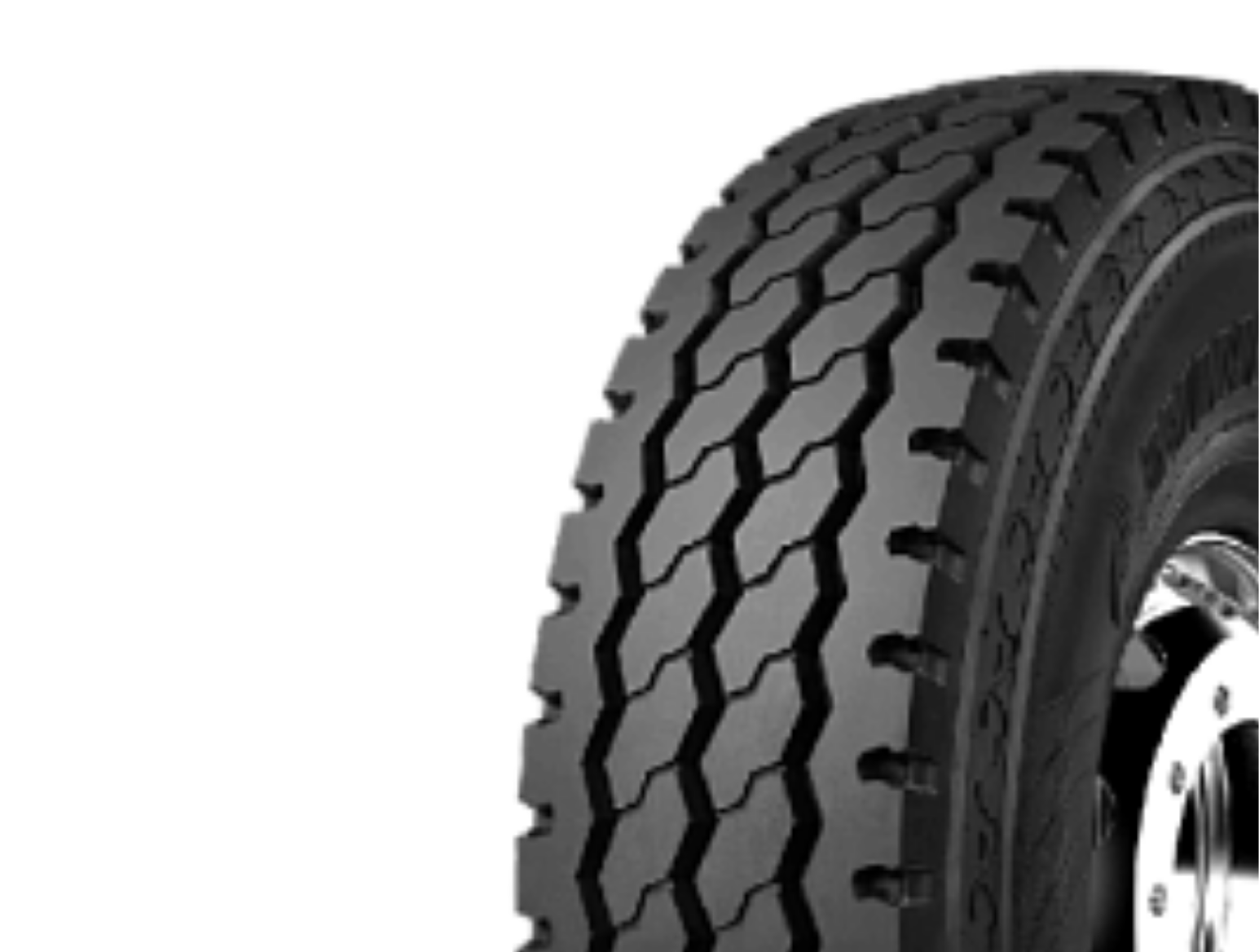 WGC29 All Position Windpower Tyre. Close-up of a black off-road tire with aggressive tread pattern and a silver wheel rim.